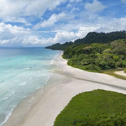On the beach, white sand, sun-loungers, beach umbrellas