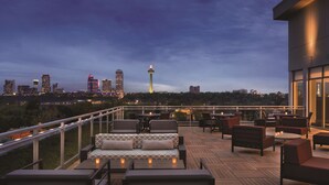 A rooftop terrace with outdoor seating and a city skyline view. - Hyatt Place Niagara Falls (Niagara Falls)
