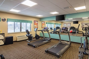 A gym with treadmills, exercise bikes, and a weight machine. - Suburban Studios Monaca - Pittsburgh (Monaca)