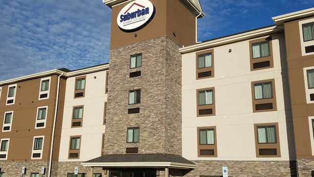 A Suburban Extended Stay Hotel with a prominent sign, multiple floors, and a parking lot with handicapped spaces. - Suburban Studios Monaca - Pittsburgh (Monaca)