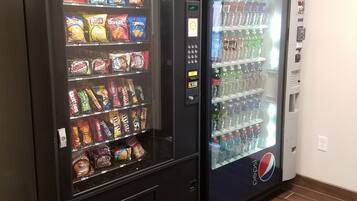 A vending machine with snacks and a Pepsi refrigerator.