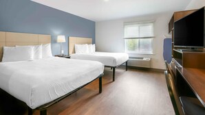 A hotel room with two beds, a TV, and a window with blinds. - Extended Stay America Select Suites Tampa Brandon East (Tampa)
