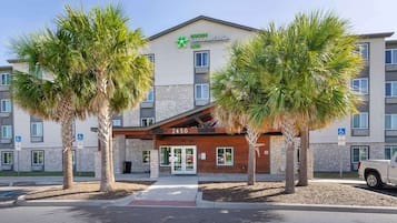 StayAmerica Suites offers a modern entrance with a clear path and a glass door.