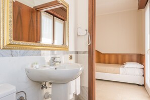 A bathroom with a marble sink, a large mirror, and a telephone. - Albergo Villa Priula (Sorisole)