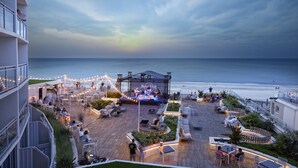 A rooftop bar with a stage for live music, outdoor seating, and a view of the ocean. - Hard Rock Hotel Daytona Beach (Daytona Beach)