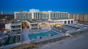 A hotel with a rooftop pool, multiple balconies, and a Hard Rock sign. - Hard Rock Hotel Daytona Beach (Daytona Beach)