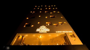 A hotel named "The Maureen Kolkata" with a modern design, featuring illuminated windows and a prominent sign. - The Maureen (Barasat)
