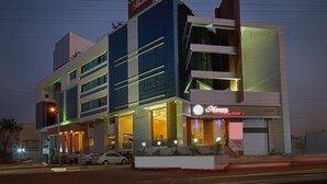 A modern hotel with a prominent sign for 'Hotel Seven Heaven'. - HOTEL SEVEN HEAVEN (Nashik)