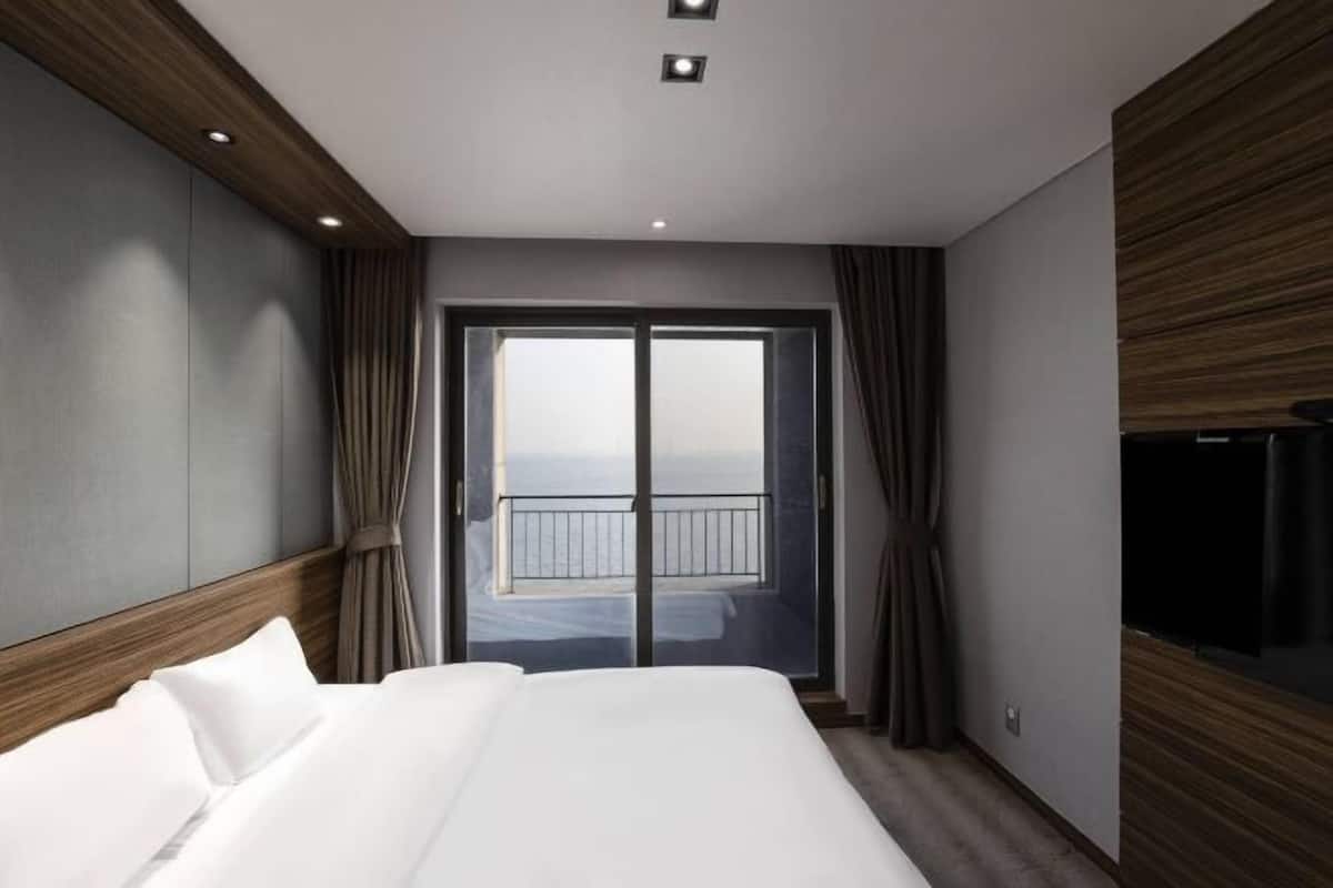 Premium bedding, desk, laptop workspace, blackout drapes
