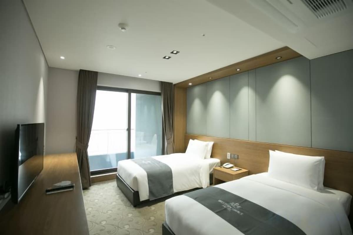 Premium bedding, desk, laptop workspace, blackout drapes