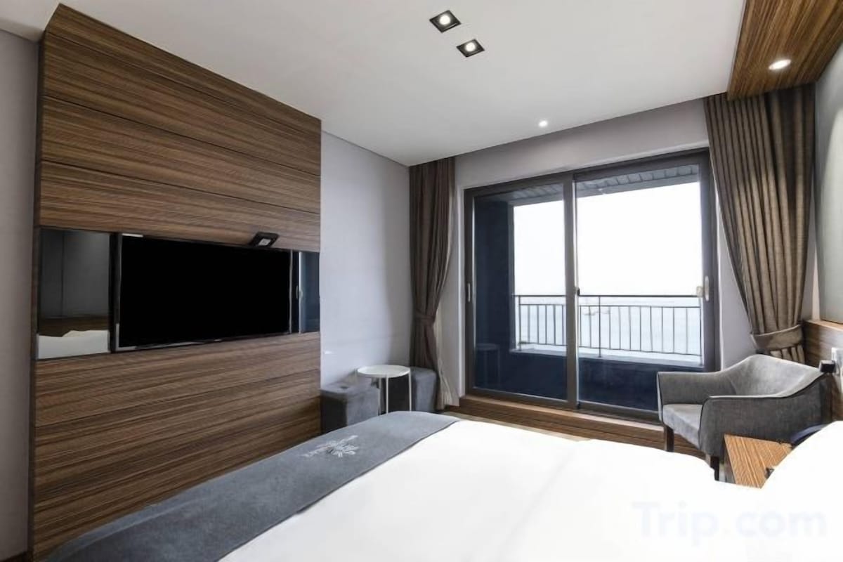 Premium bedding, desk, laptop workspace, blackout drapes