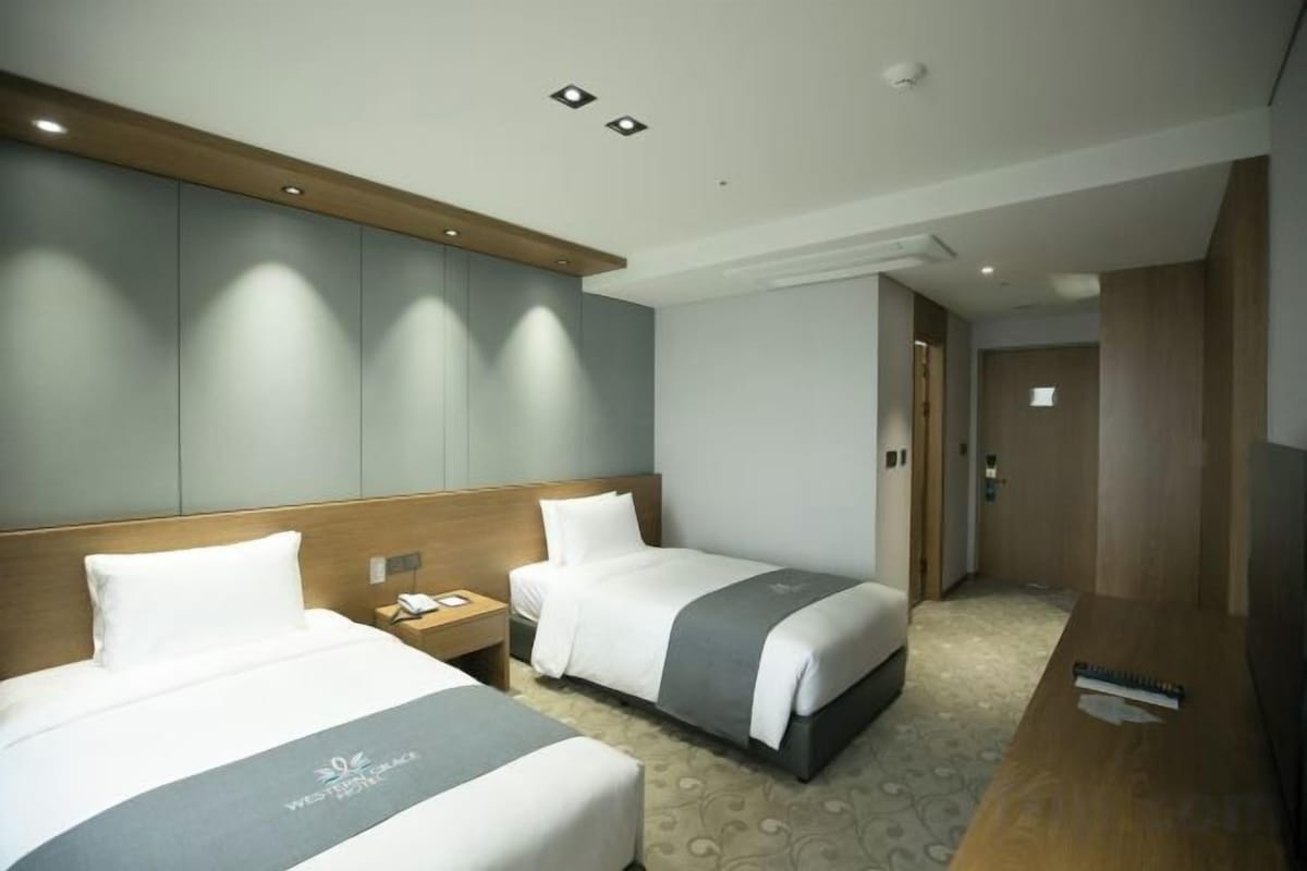 Premium bedding, desk, laptop workspace, blackout drapes
