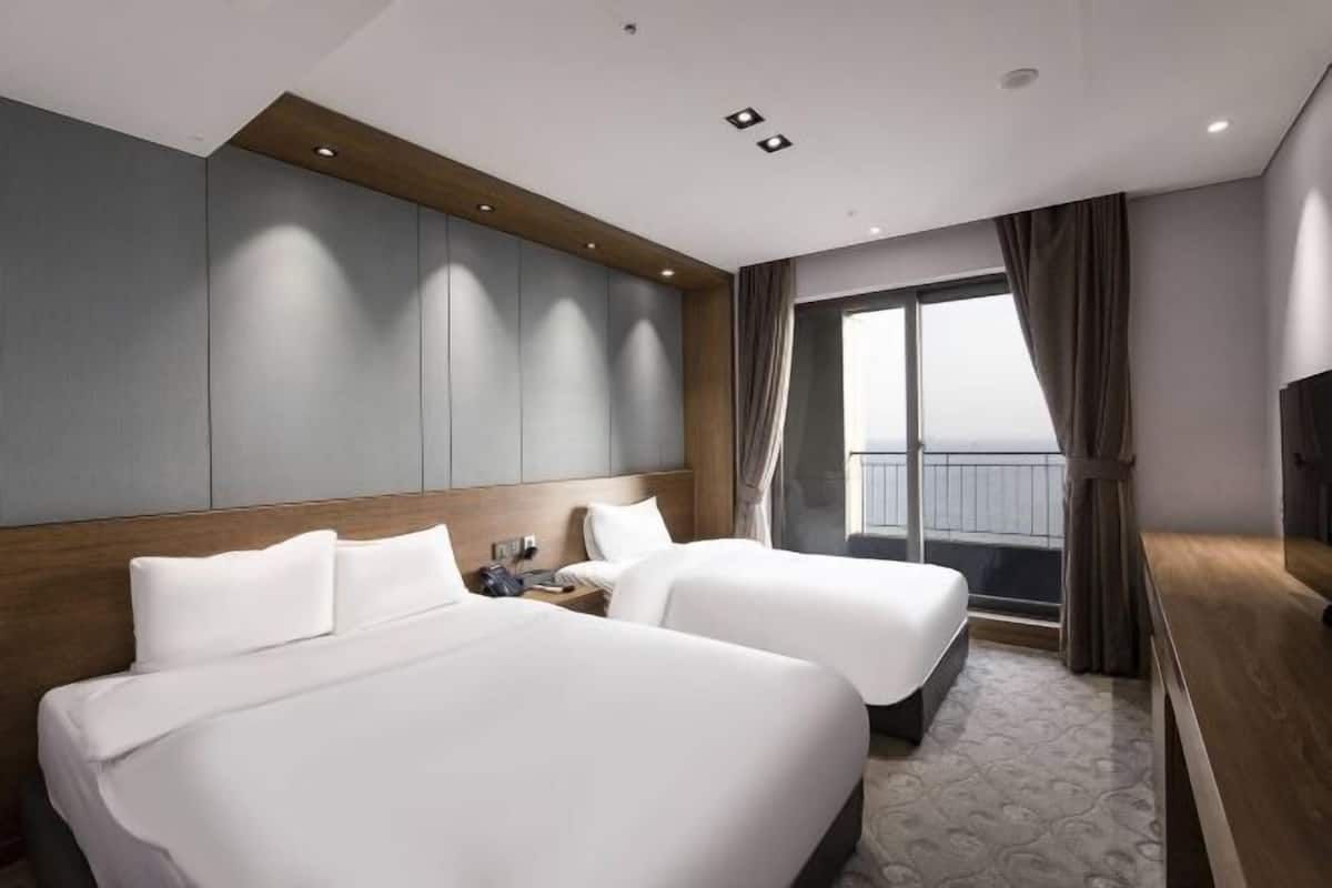 Premium bedding, desk, laptop workspace, blackout drapes