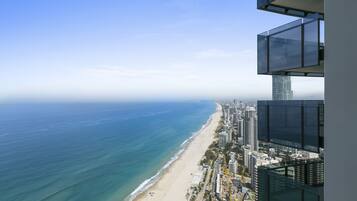 A high-rise building with a view of a beach and ocean.