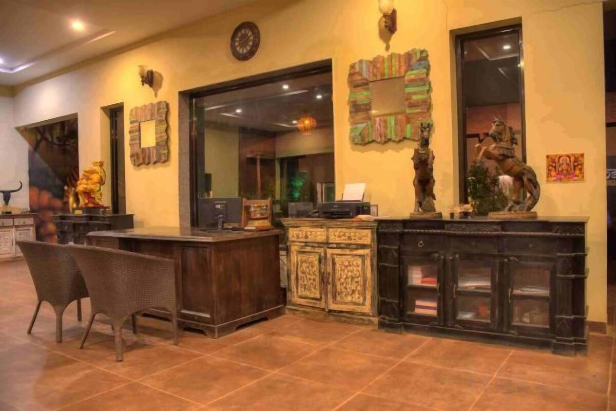 A reception area with a reception desk, chairs, and decorative items.