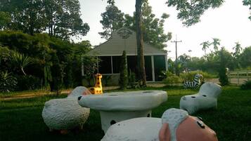Surrounded by lush greenery, this tranquil setting features animal-shaped sculptures amidst a serene outdoor space.