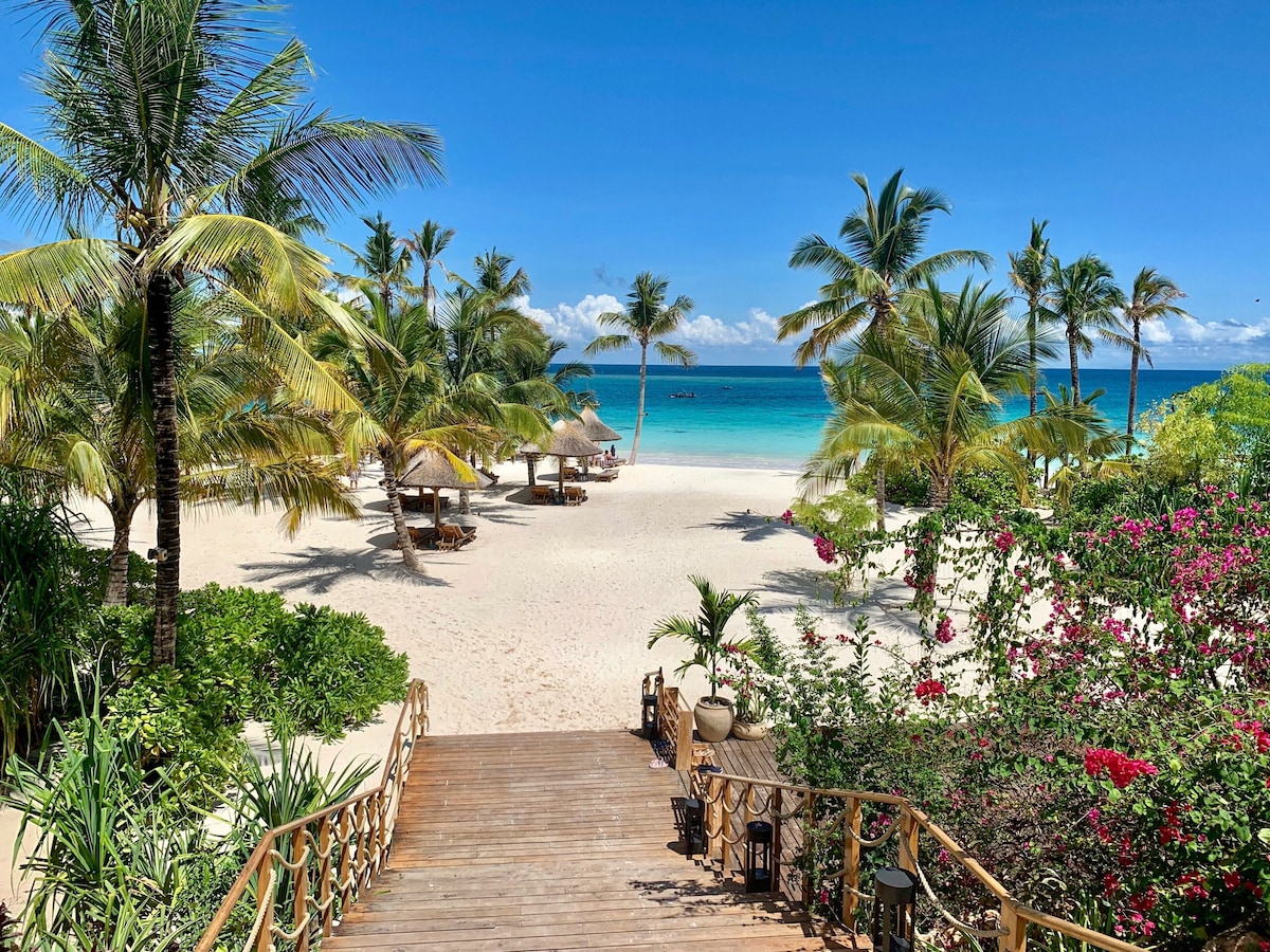Zanzibar beach resort with tropical palms and turquoise ocean