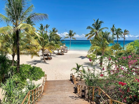Outdoor pool, pool umbrellas, sun loungers. Zuri Zanzibar