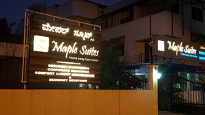 A sign for Maple Suites advertising services like corporate residences and luxury condos. - Maple Suites (Bengaluru)
