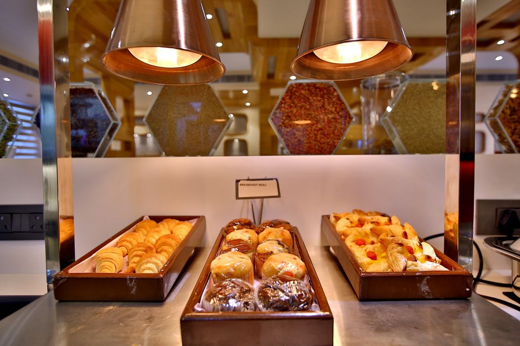 A breakfast buffet with various pastries and baked goods.