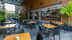 Un restaurante con terraza, paredes de madera y vistas a la ciudad.