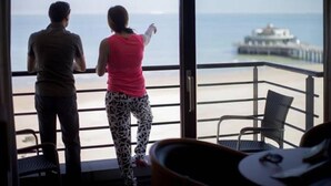 Un balcon avec vue sur la mer et un quai.