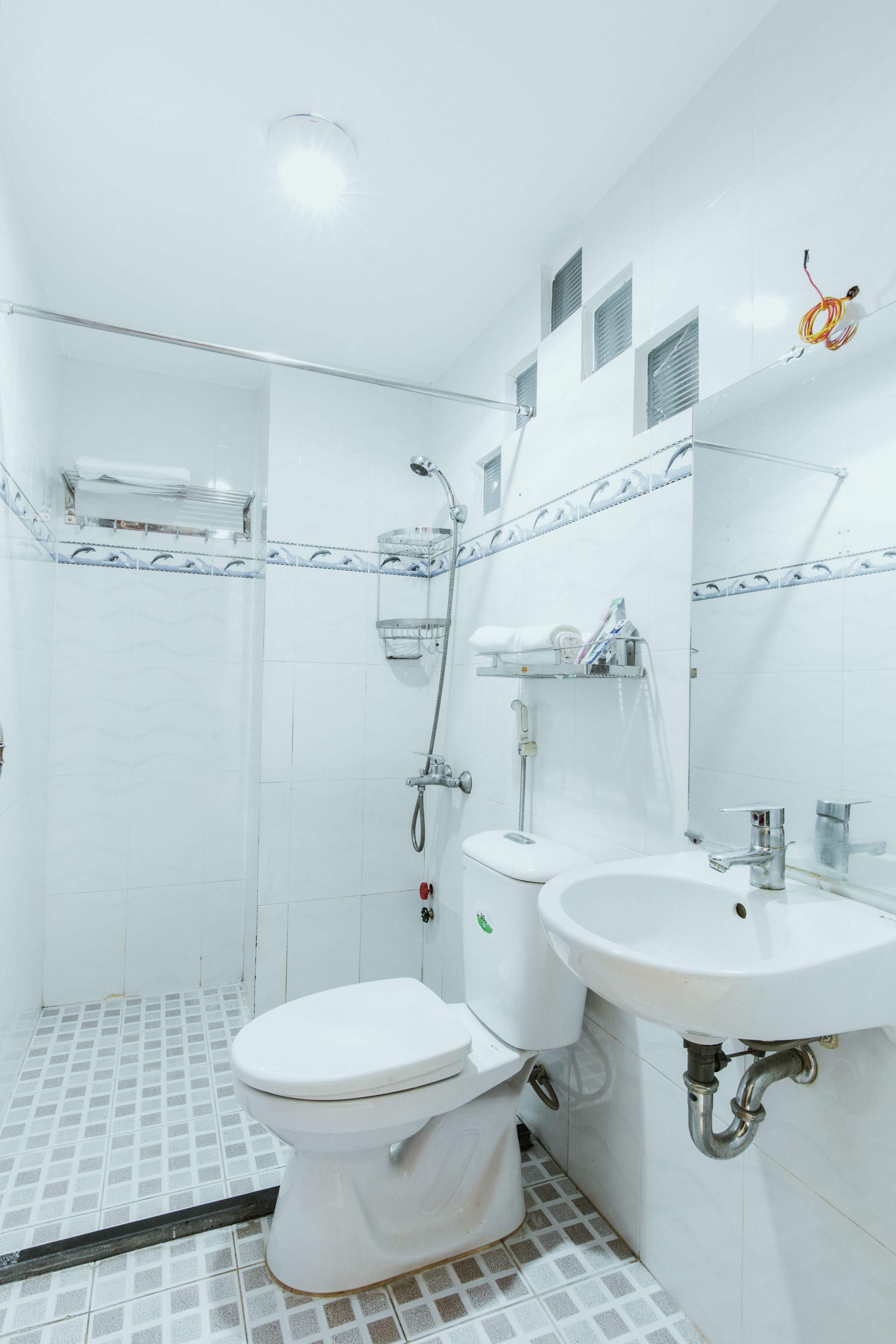 A bathroom with a toilet, sink, and shower.