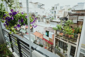 A residential area with multiple buildings, some with balconies and potted plants. - Urban House Saigon 2 (Ho Chi Minh City)