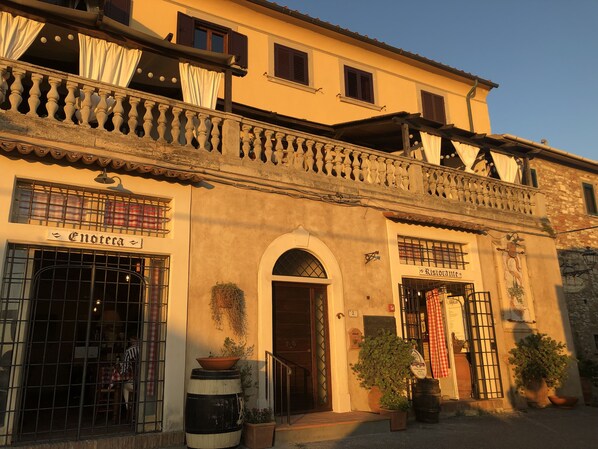 A building with a sign reading "Ristorante" and a potted plant in front.