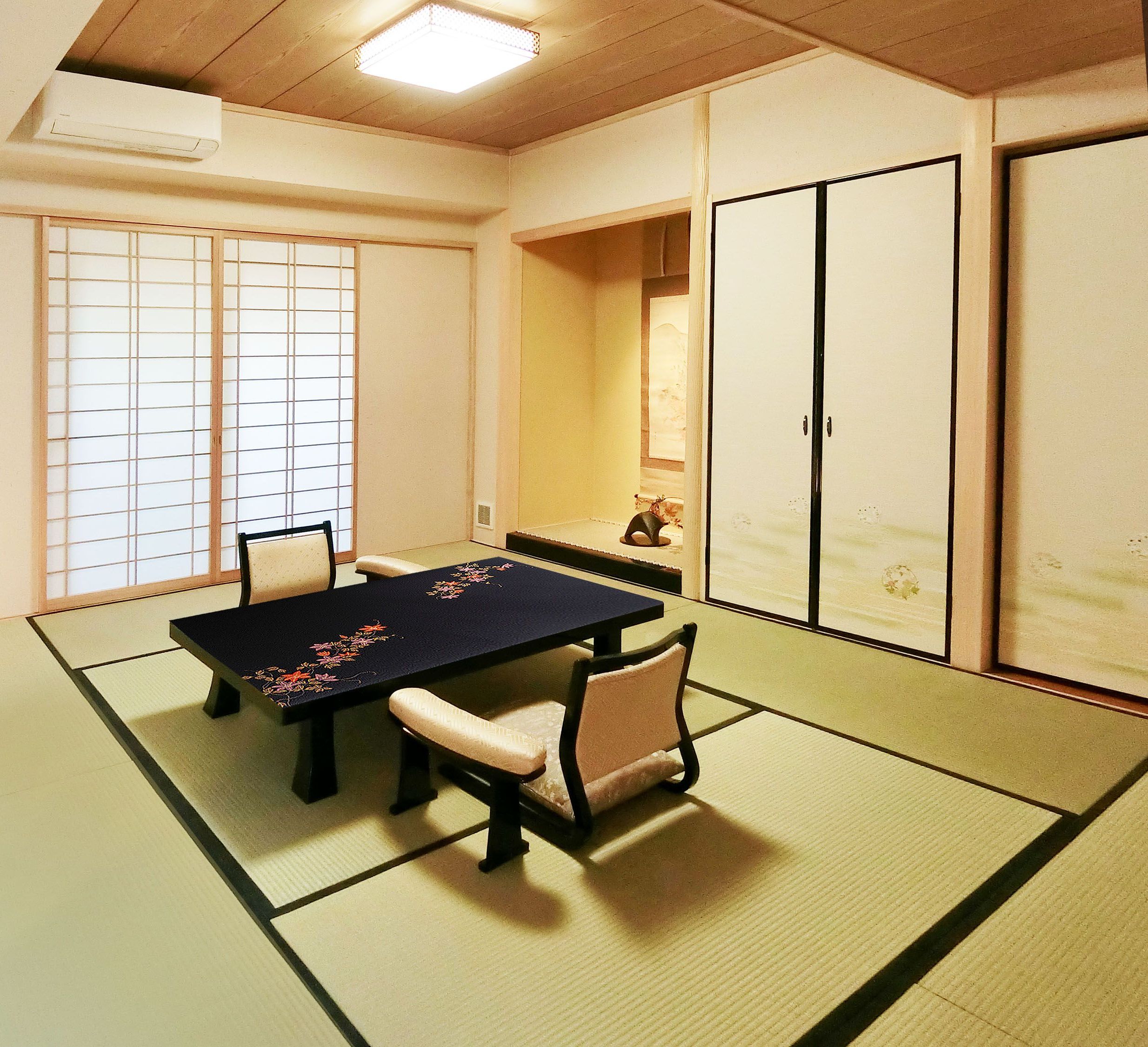 A traditional Japanese room with tatami flooring, a low table, and shoji screens.