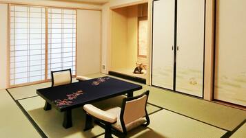A traditional Japanese room with tatami flooring, a low table, and shoji screens.