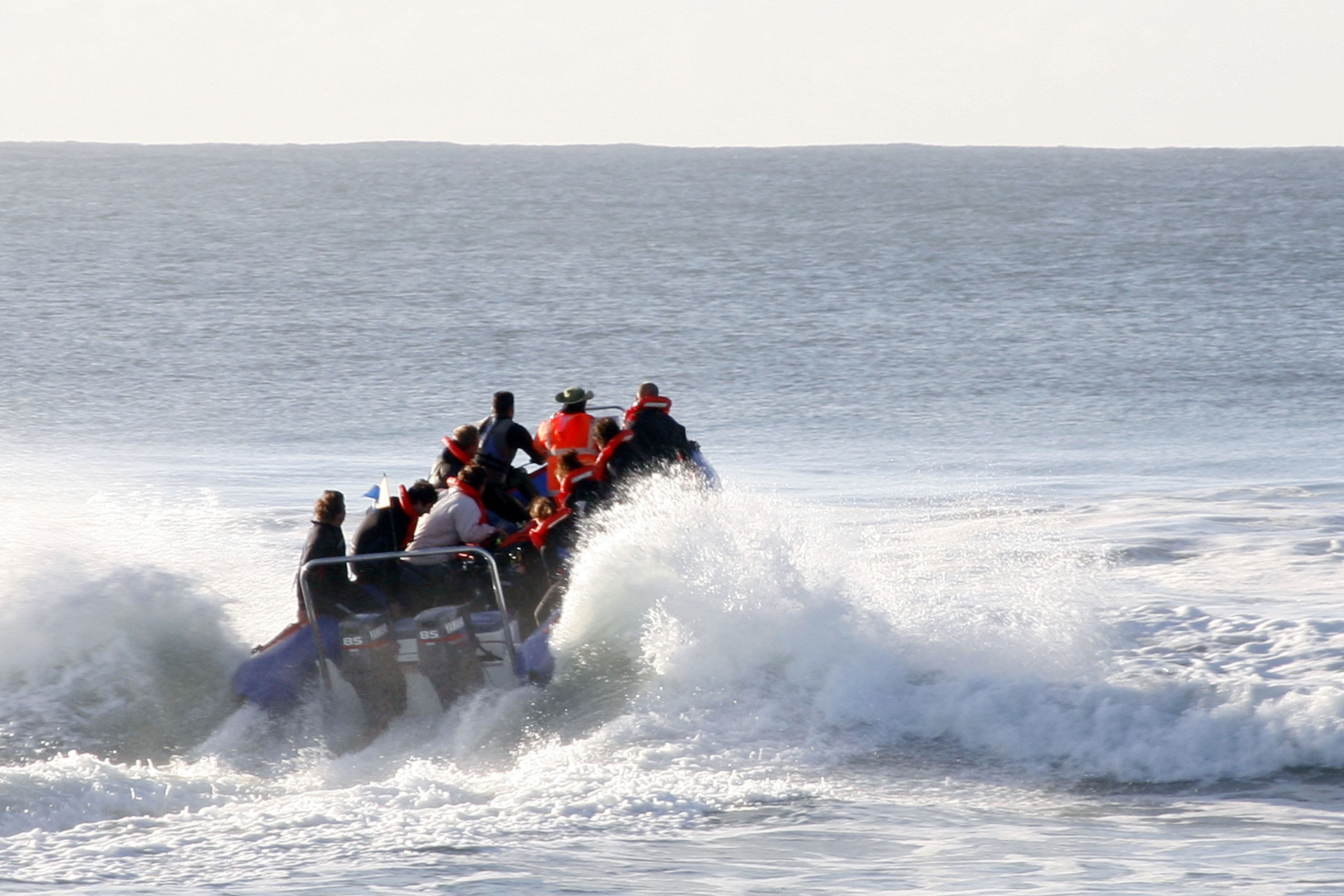A group of people on a watercraft in a body of water.