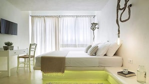 A modern bedroom with a bed, bedside table, and a desk area. - IridaChic Boutique Hotel & Spa (Hersonissos)