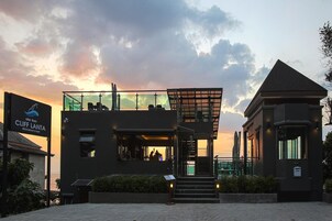 A modern building with a glass facade, a staircase, and a sign for Cliff Lanta restaurant & bar.