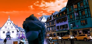 A street view with traditional European architecture, including a building with a pointed roof and another with a gabled facade. - Tilly's B&B (Le Hohwald)