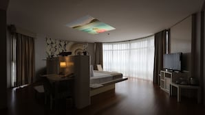 A modern hotel room with a bed, desk, and television. - Orucoglu Oreko Hotel (Manisa)