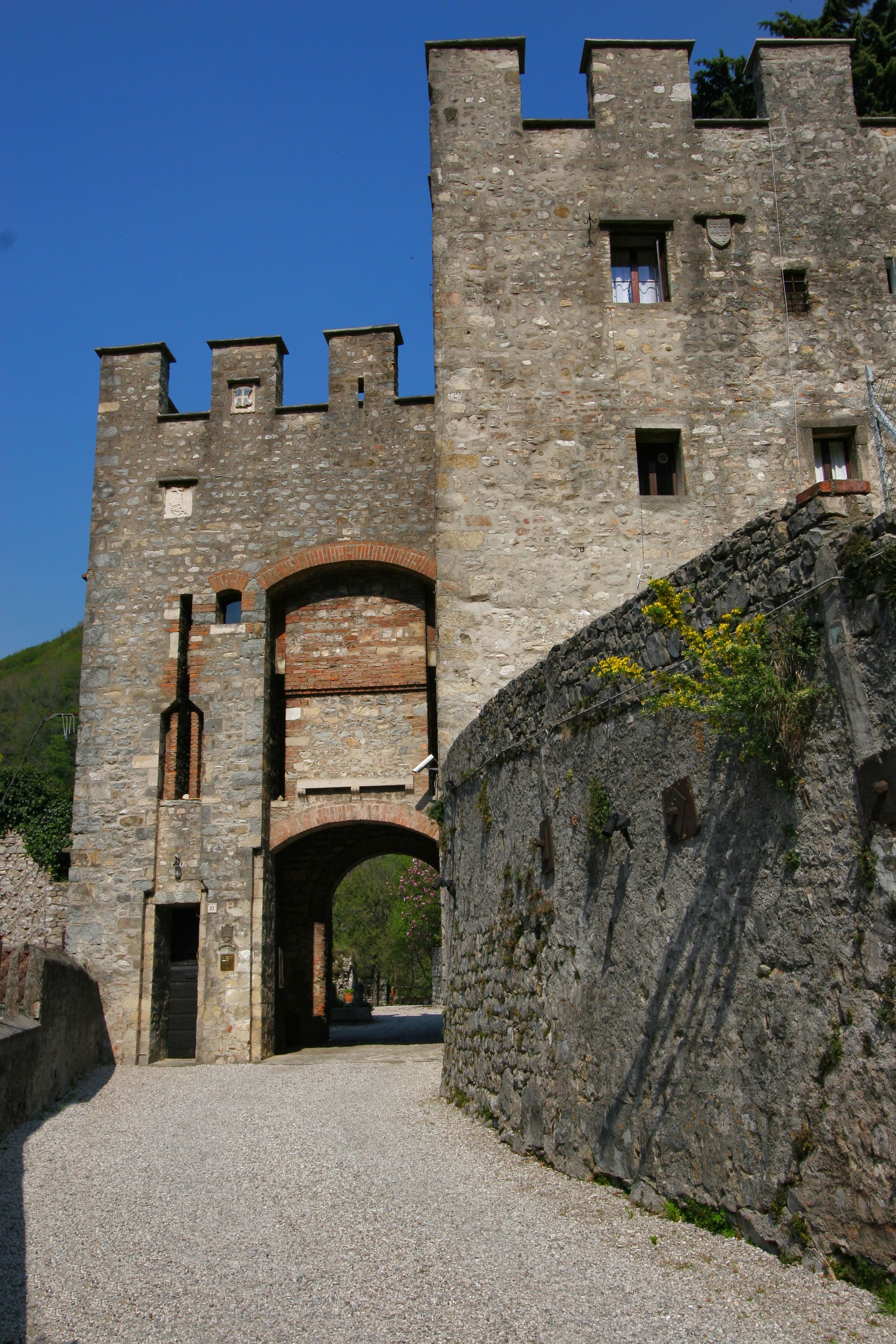 A stone castle with a large arched entrance and multiple windows.