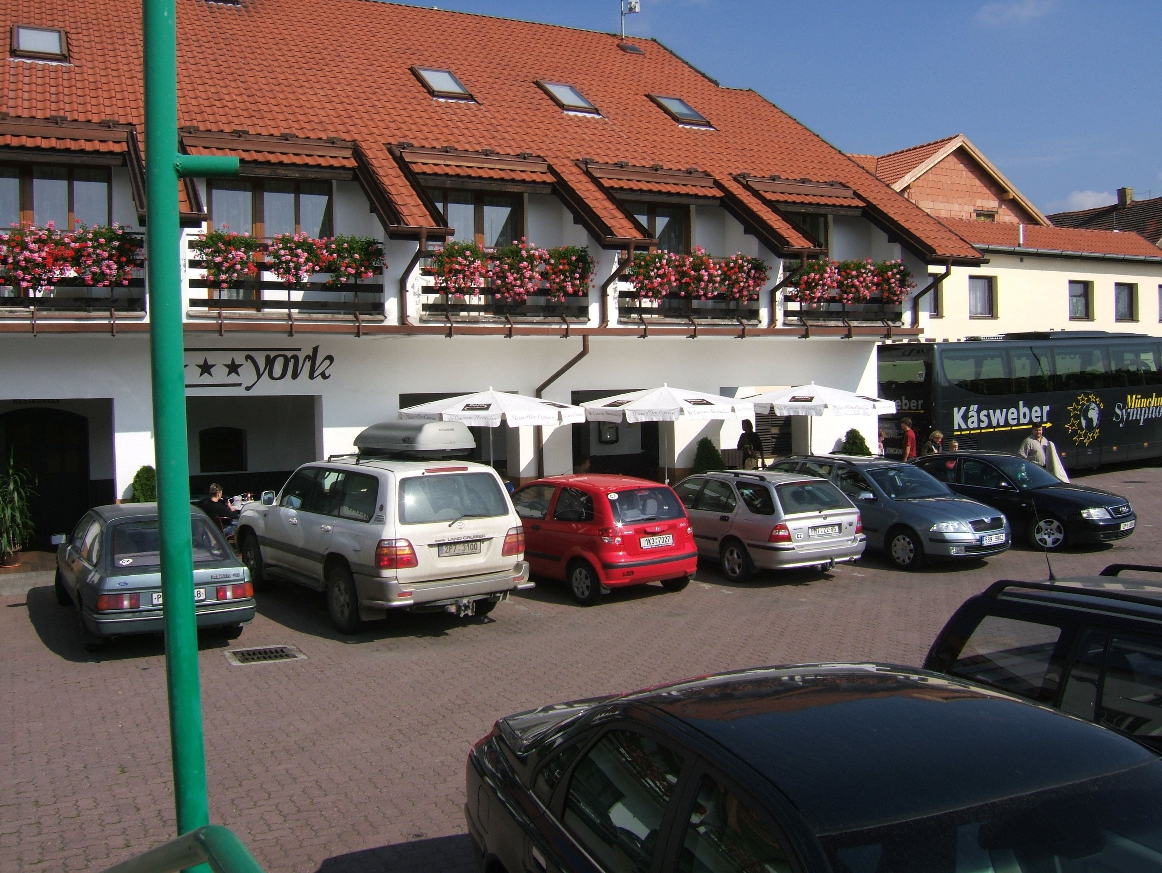 A hotel with a red-tiled roof, balconies with flower boxes, and a sign reading "york".