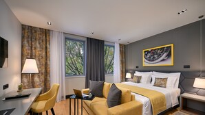A modern hotel room with a bed, a desk, a chair, and a large window. - Sia Split Hotel (Split)