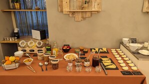 A breakfast buffet with various food items and condiments. - Hôtel Le Quatorze (Figeac)