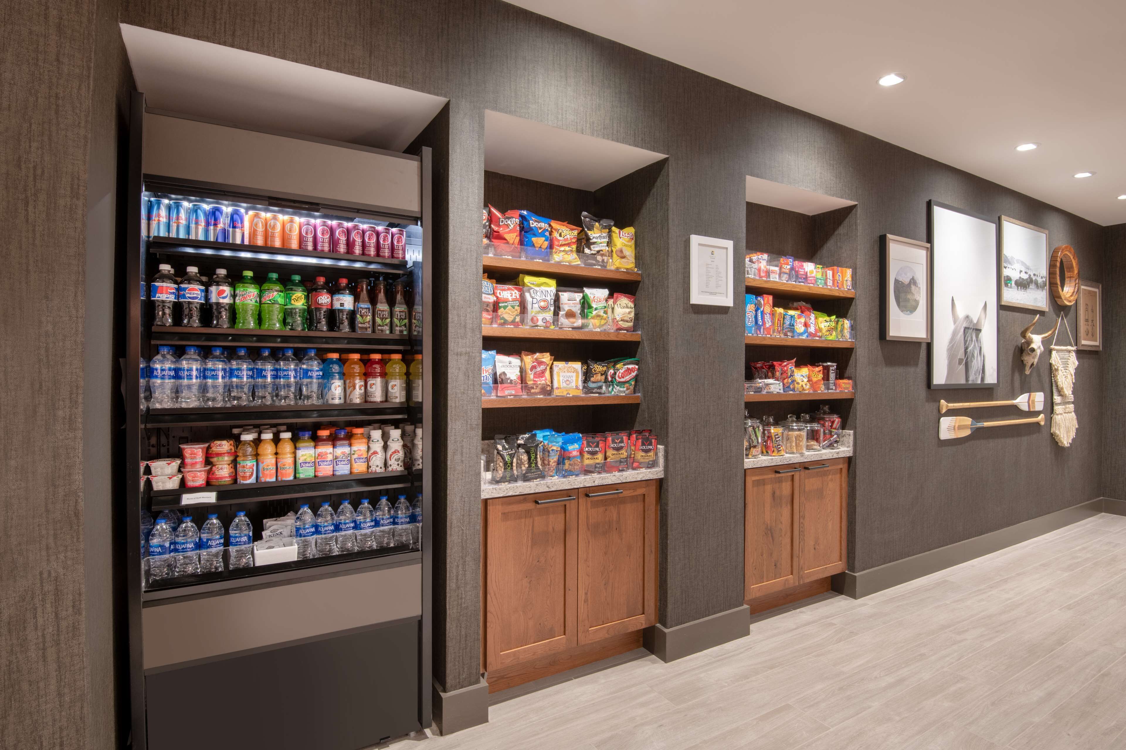 A beverage vending area with various drinks and snacks.