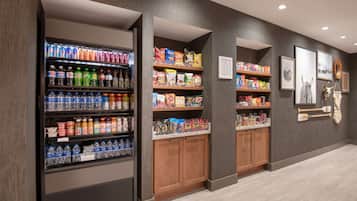 A beverage vending area with various drinks and snacks.