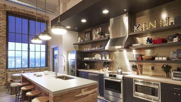 A modern kitchen with a large island, stainless steel appliances, and wooden accents. - Kinn Guesthouse Bay View (Milwaukee)