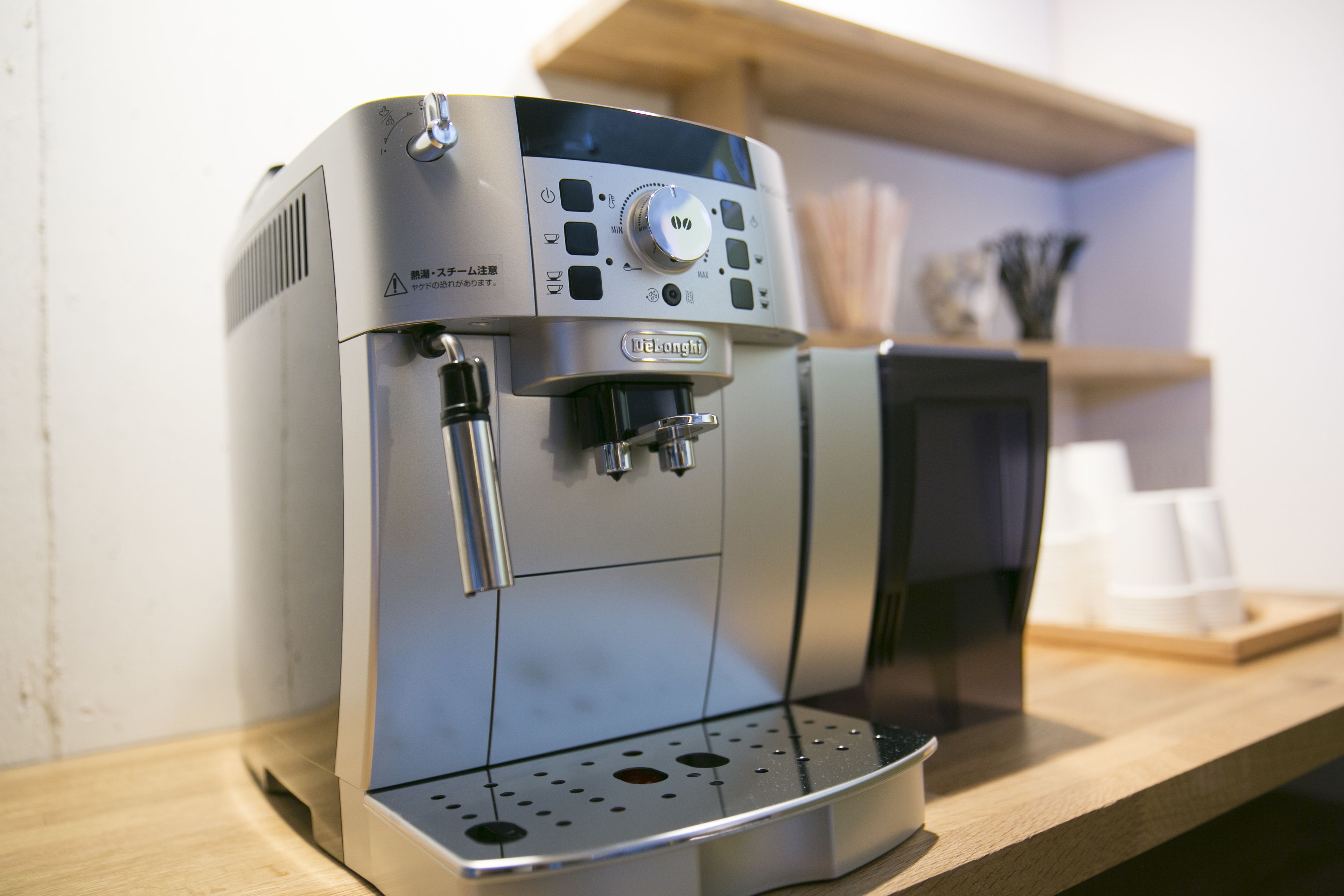 A coffee machine with a control panel and a water reservoir.
