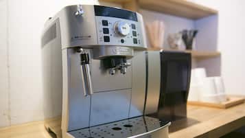 A coffee machine with a control panel and a water reservoir.