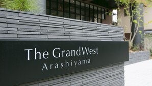 A sign for The GrandWest Arashiyama, indicating the hotel's name and location.