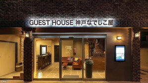 A hotel entrance with a sign reading "GUEST HOUSE". - Guest House Kobe Nadeshikoya - Hostel (Kobe)