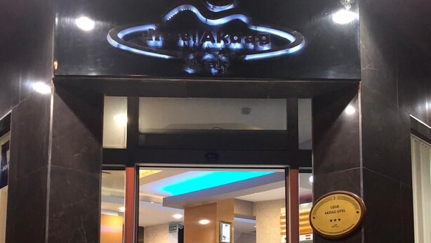The entrance to Hotel Akdag with a reception desk, a plaque indicating a 4-star rating, and a blue-lit ceiling. - Hotel Akdag (Usak)