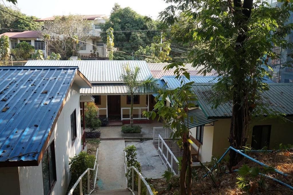 A residential area with houses, a central courtyard, and a staircase leading to a second floor.