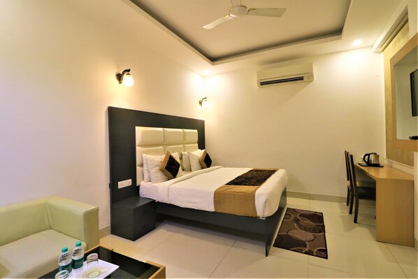 Relax in comfort with a centrally positioned bed and cozy seating area.